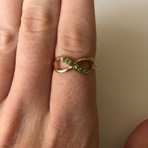 Gold Infinity ring with green stones